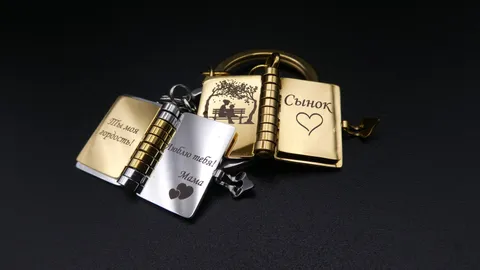 A custom metal miniature book keychain with micro-engraved personal messages. A sentimental gift from a mother to her children, featuring precision fiber laser detailing by TechArt Concept.