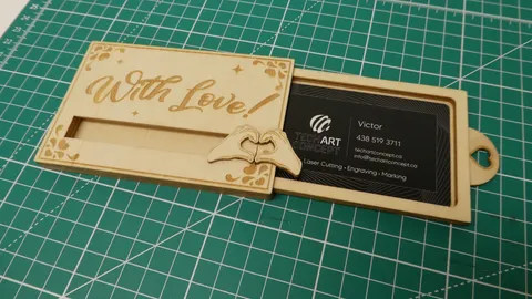 Custom wooden business card case opening to reveal laser marked black corporate card.