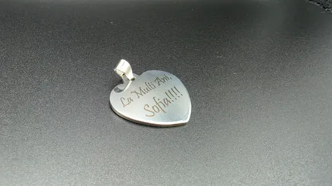 Custom heart pendant laser engraved with a elegant Romanian birthday message on a matte black background.